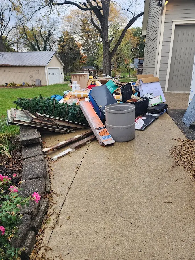 Dumpster being loaded with debris for 3 Yard Dumpster Rental in Highland Acres